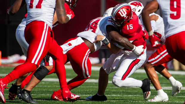 Nov 4, 2023; Bloomington, Indiana, USA; Indiana's Brendan Sorsby (15) is sacked during the first half against Wisconsin at Memorial Stadium. Mandatory Credit: Rich Janzaruk-USA TODAY Sports